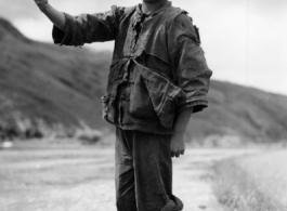 Local boy in China give sa 'ding hao' thumbs-up to the photographer during WWII.