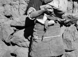 Local kids in Yunnan province, China, during WWII: A girl holds an infant.