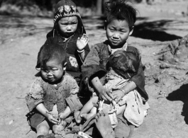 Local people in China during WWII: And older child takes care of younger children. During WWII.