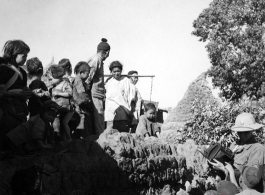 Local people in Yunnan province, China, are curious about the visit of a American photographer, during WWII.