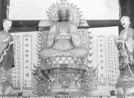 Figures in a Buddhist temple in Yunnan province, China, during WWII.