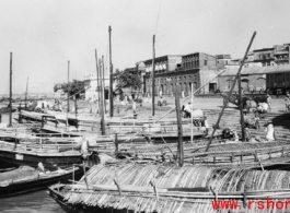 Boats at a mooring, and people, in India during WWII.