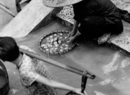 Local people washing vegetables  in Liuzhou city, Guangxi province, China, during WWII.