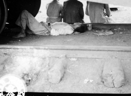 During WWII, a refugee from the advancing Japanese troops at Kweilin catches a nap under the wheels of a railroad car at the south station, Liuchow, China.