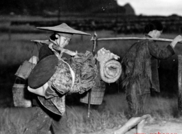 Refugees carry possession while fleeing around either Liuzhou or Guilin during the evacuation before the Japanese Ichigo advance in 1944, in Guangxi province.