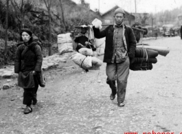 Refugees fleeing around either Liuzhou or Guilin carry possessions during the evacuation before the Japanese Ichigo advance in 1944, in Guangxi province.