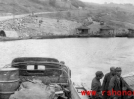 On a ferry with Chinese soldiers crossing a river in southwest China during WWII.