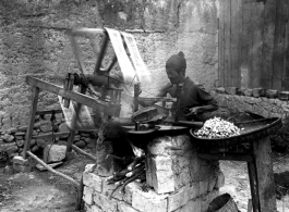 A street-side silk spinner, in SW China, during WWII.