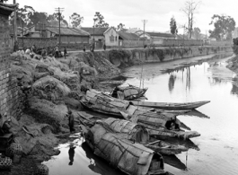 Boats in a canal in Yunnan province, China, possibly near Kunming, during WWII.