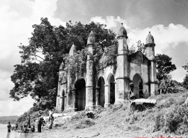 An overgrown riverside structure in the countryside of India or Burma, during WWII.