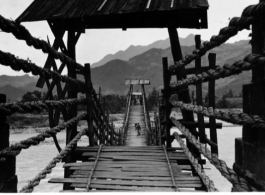 All bamboo "cables" and wood walkway suspension bridge over Min River, Guan county (Guanxian/Kwan Hsien), China, August 1945.  Photo from Selbert.