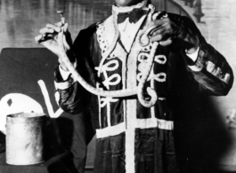 A snake show performer puts on a show for the troops in the CBI.