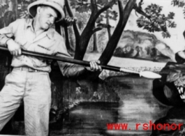 A GI pretends to fight a tiger in a fake forest in a studio in the CBI during WWII.