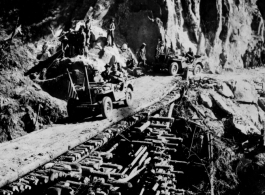 First jeep crosses log bridge near the Burma border.   U. S. Army phot