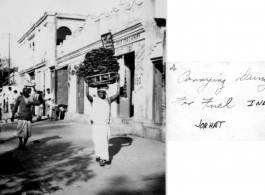 A woman in Jorhat, India, carries dried dung for fuel. During WWII.