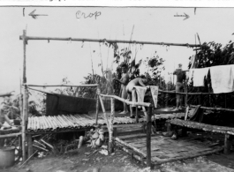 GIs bathing at outdoor showers at Tagap, Burma, during WWII. 1944.