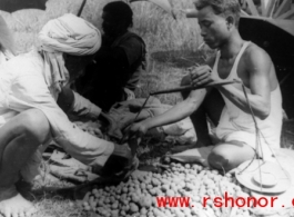 Measuring produce at farmer's market, Misamari, India, during WWII.