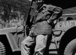 16th Combat Camera Unit photographer Hal Geer leans against jeep as he poses in Liuzhou in 1945.