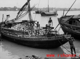 A boat full of coconuts in India or Burma, during WWII.