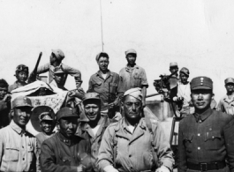 Soldiers pose at junction of Burma & Ledo Roads during WWII.