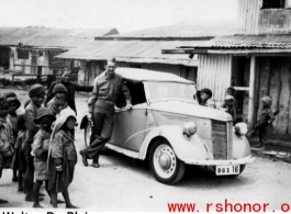 GI leans against car in the CBI during WWII. Walter De Blair.