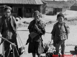 Three firewood peddlers in China during WWII.  Photo from Emery and Beth Vrana.