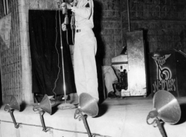 GI plays guitar while the band Jive-o-Lieps waits to music in the CBI during WWII. 54th Air Service Group.