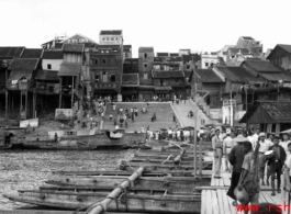 Looking toward the other side of Liuzhou on the boat bridge. Johnnie Burns is a couple of boats ahead, looking back. The barge is off to the left where the kids are swimming.  From the collection of Frank Bates.