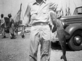 GI holding shark in Karachi, India 1942.  From the collection of Frank Bates.