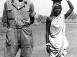 A GI and a woman carrying a pot on here head. India 1942 or 1943.