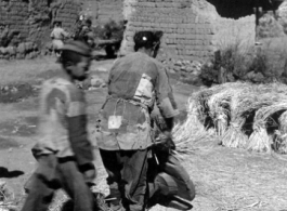 A close-up of rice threshing from the first village on the way to Yangkai. During WWII.