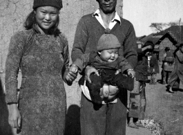 A couple with their young baby boy, probably at Yangkai (Yangjie), in Yunnan province.