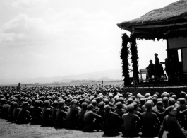 Chinese soldiers sit on ground listening to speech during exercises in southern China, probably Yunnan province, or possibly in Burma.