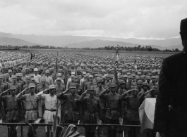 Chinese soldiers stand in ranks during a ceremony during exercises or ceremony in southern China, probably Yunnan province, or possibly in Burma.