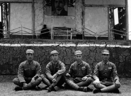 Chinese soldiers sit cross-legged in front of stage during rally in southern China, probably Yunnan province, or possibly in Burma.