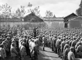 Chinese soldiers in dense formation listen to speech during rally.