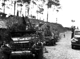 Chinese soldiers with equipment ready and covered in camouflage riding an American M3 Scout Car during exercises in southern China, in Yunnan province.