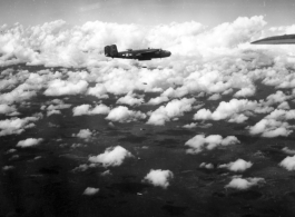 B-25 Mitchell bombers in flight and dropping bombs in the CBI, in the area of southern China, Indochina, or Burma.