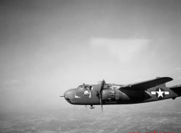 B-25 Mitchell bomber in flight in the CBI, in the area of southern China, Indochina, or Burma. During WWII.