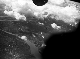 B-25 Mitchell bombers fly over a large city in the CBI during WWII, in 1943.