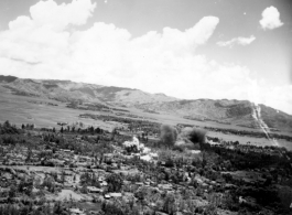 A explosion in Japanese-held Tengchong, probably from a bomb dropped by B-25 Mitchell bombers during battle with Japanese ground forces, flying over Tengchung (Tengchong), near the China-Burma border in far SW China.