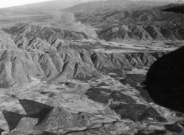 Smoke rises after attack by B-25 Mitchell bombers during battle with Japanese ground forces, flying in the rough area of Tengchung (Tengchong), near the China-Burma border in far SW China.