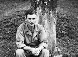 An image showing the GI photographer and collector of these photos (name unknown) sitting in front of a tomb, in Yunnan province, China.