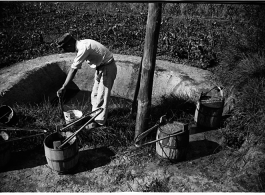 Farmer processing fertilizer (night soil) for the gardens. In Yunnan, China, during WWII.