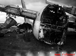 An image from the Roubinek Collection, showing a wrecked and broken-backed B-24 bomber in a boneyard near the base. in Yunnan province, China, most likely around the Luliang air base area.