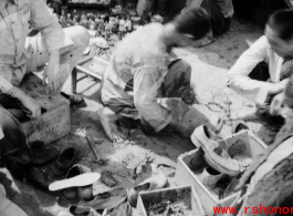 Streetside shoe repair in Yunnan, China, during WWII.