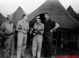 An image from the Roubinek Collection, showing American GIs and street scenes in India: GIs play music in front of tent in India.