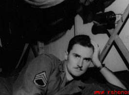 The collector posing on his bunk in the barracks. Likely in Yunnan province. During WWII.