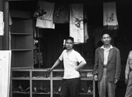 Men at the door of a small store in Yunnan, China, possibly near an American base at Luliang or Chanyi (Zhanyi). During WWII.