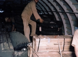 An assortment of supplies, including a four-wheeled vehicle, inside a US C-46 transport plane in the CBI during WWII.